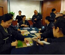 慈濟志工們分秒不空過，一起製作家屬識別證。（攝影者：雍妮 地點：北京）