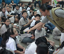 志工陳燕婷以一問一答或有獎問答遊戲方式與孩子們互動。【攝影者：余秀娟（慈岸）】