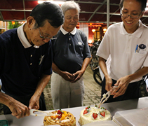 環保活動結束後，夜間環保點的站長劉昌寶（濟樸，左）代表環保志工進行簡單的切蛋糕儀式。【攝影者：翟佩庭】
