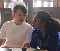 護理師李曉茹為不諳中文的印裔學生翻譯影片及分享者的內容。【攝影者：尤靜蓓】