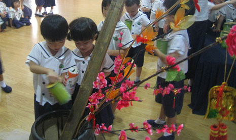 五歲班的小朋友們排隊把竹筒裡的愛心，倒進大甕裡。【攝影者：翟佩庭】