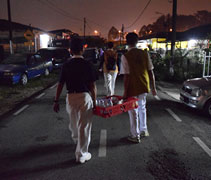 志工們踏著夜色，挨家挨戶送麵包和飲用水，安撫居民們驚魂未定的心。【攝影者：趙慧馨】