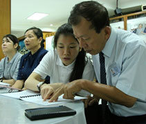 日得拉聯絡負責人劉炳坤（濟箖）師兄與女兒劉祕芸仔細翻閱訪視手冊。【攝影者：許薇盈（慈礽）】